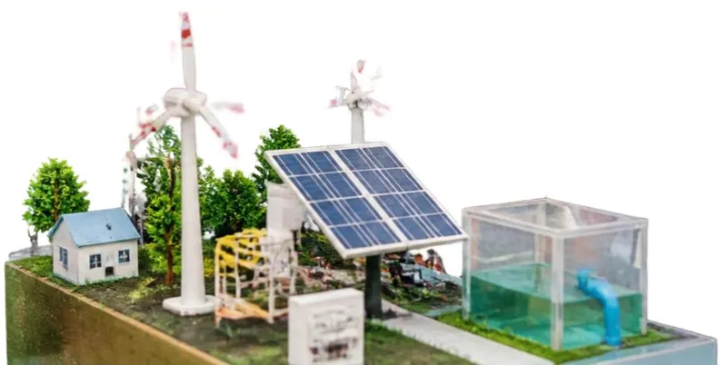 A renewable energy working model with windmills, a solar panel, a house and a water tank